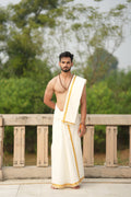 Man wearing a 1 inch golden zari border white cotton dhoti with uparana