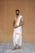 Man wearing a 4 inch golden zari border white cotton dhoti with matching uparana