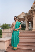 Man wearing a green Dhoti 