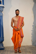 Man wearing a floral embroidery border orange dhoti with uparana