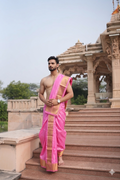 Man wearing a traditional bright pink pure silk dhoti with angavastram