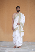 Man wearing a white dhoti with gold patterns