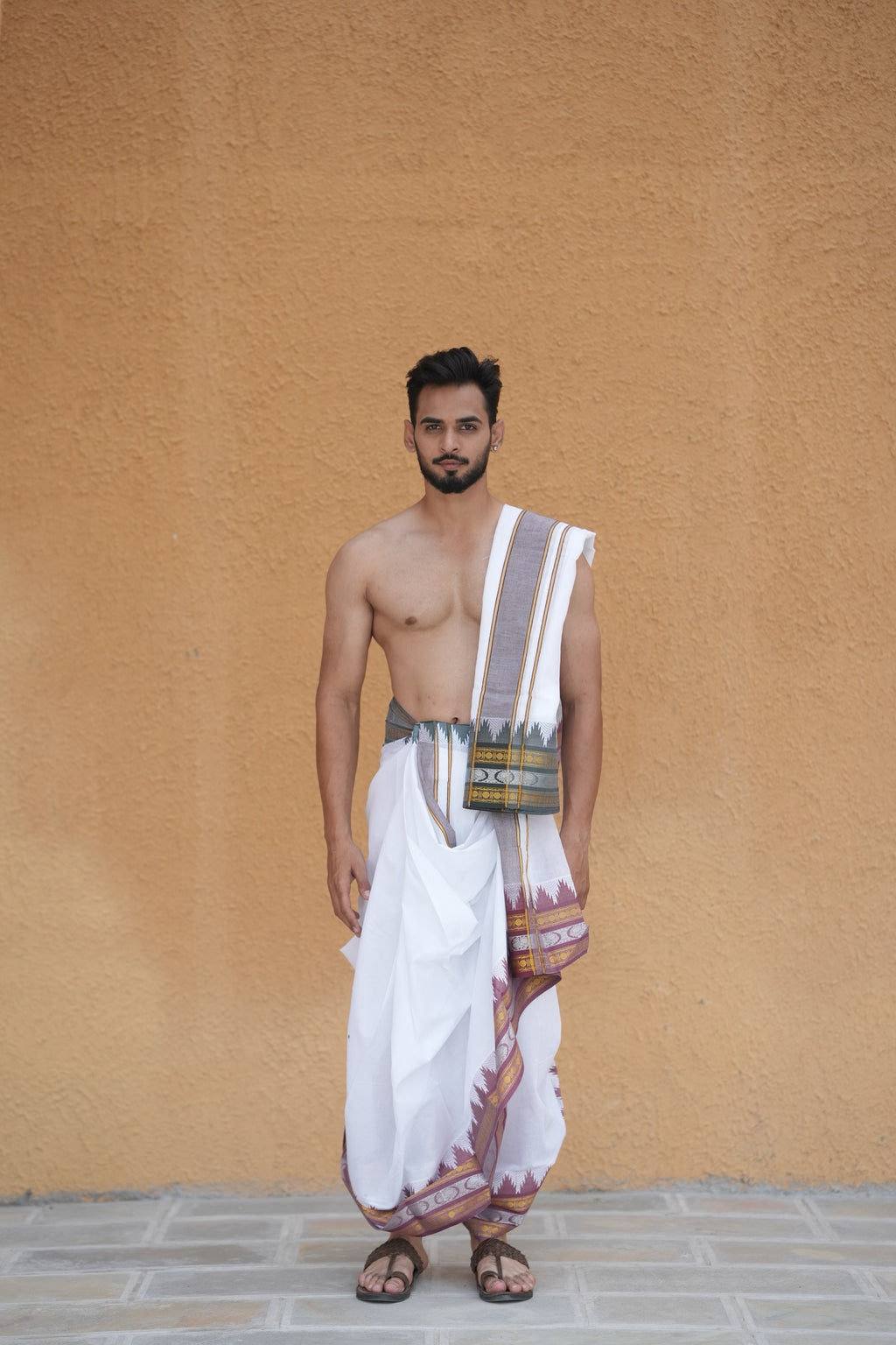Man wearing a traditional white dhoti 