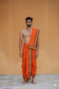 Man wearing a artisan woven border sunfire orange cotton dhoti with uparana