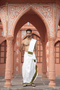 Man wearing artistic green floral handprint border white cotton dhoti with matching uparana