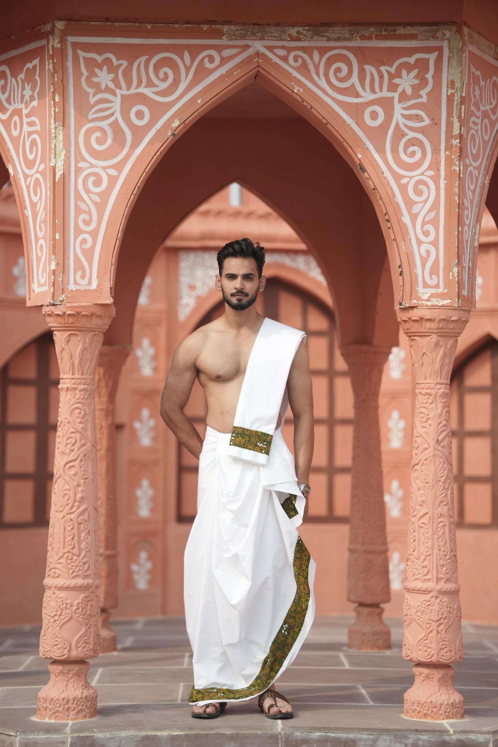 Man wearing artistic green floral handprint border white cotton dhoti with matching uparana