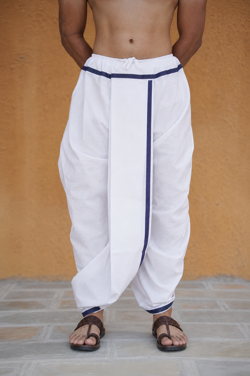 Man wearing a blue border readymade white cotton dhoti