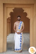 Man wearing a blue peacock border white cotton dhoti with khes
