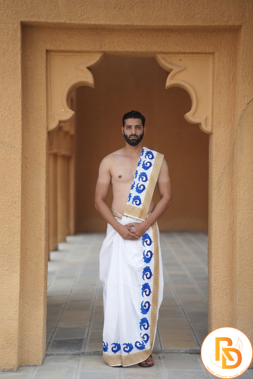 Man wearing a blue peacock border white cotton dhoti with khes
