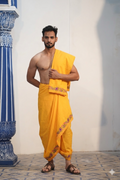 Man wearing a bright yellow embroidery border dhoti with matching uparana