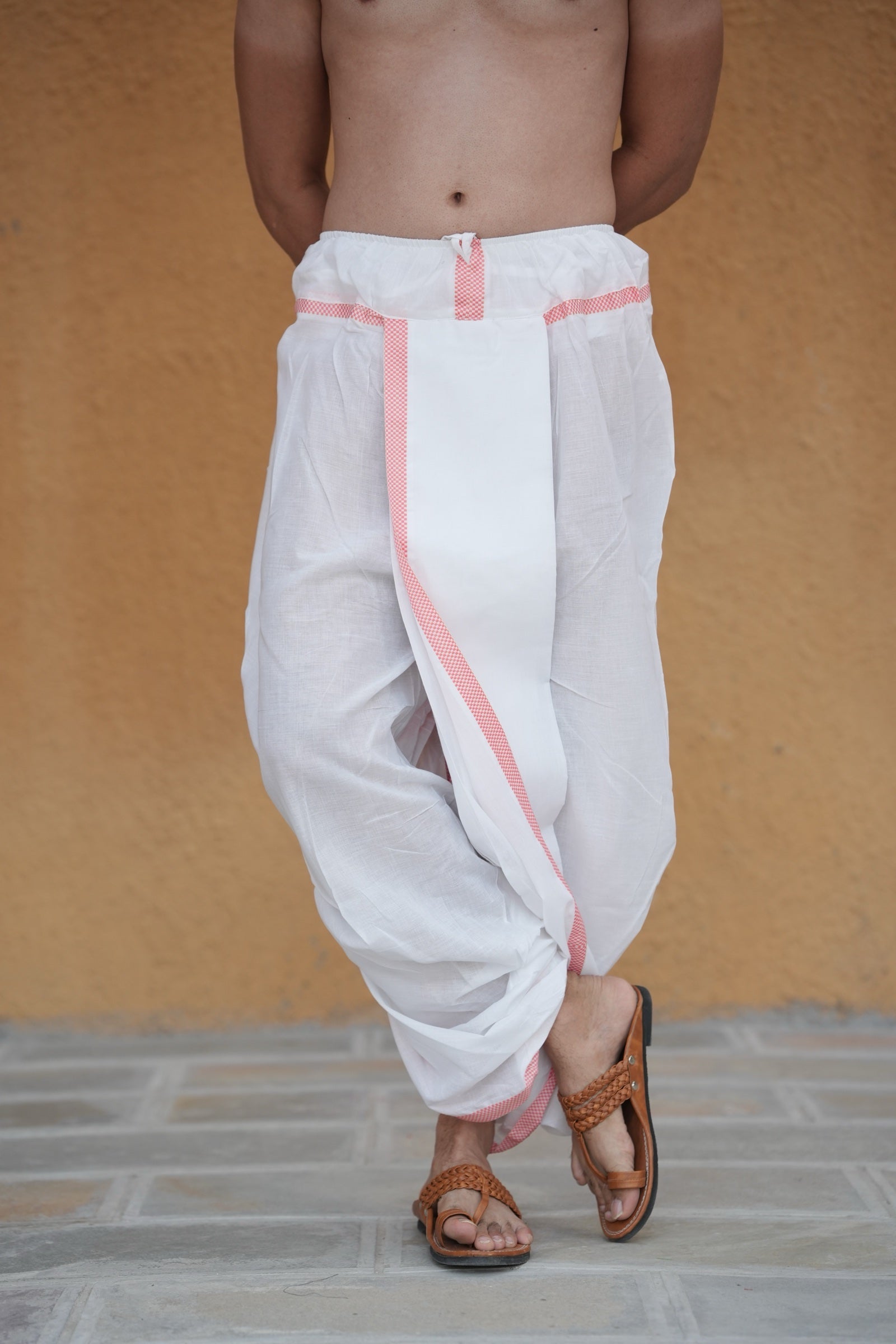 Man wearing a checks border readymade white cotton dhoti