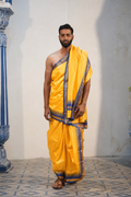 Man wearing a eye catching blue temple border yellow silk dhoti with uparana