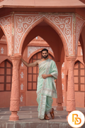 Man wearing a floral and leaf border dhoti with uparana
