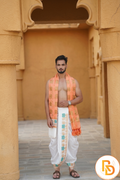 Man wearing a white dhoti with orange uparana