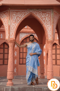 Man wearing a floral border sky blue dhoti with uparana