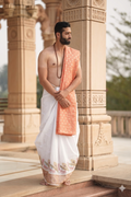 Man wearing a flute and peacock feather white dhoti with uparana