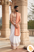 Man wearing a flute and peacock feather white dhoti with uparana