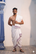 Man wearing a geometric border white cotton dhoti with gamcha
