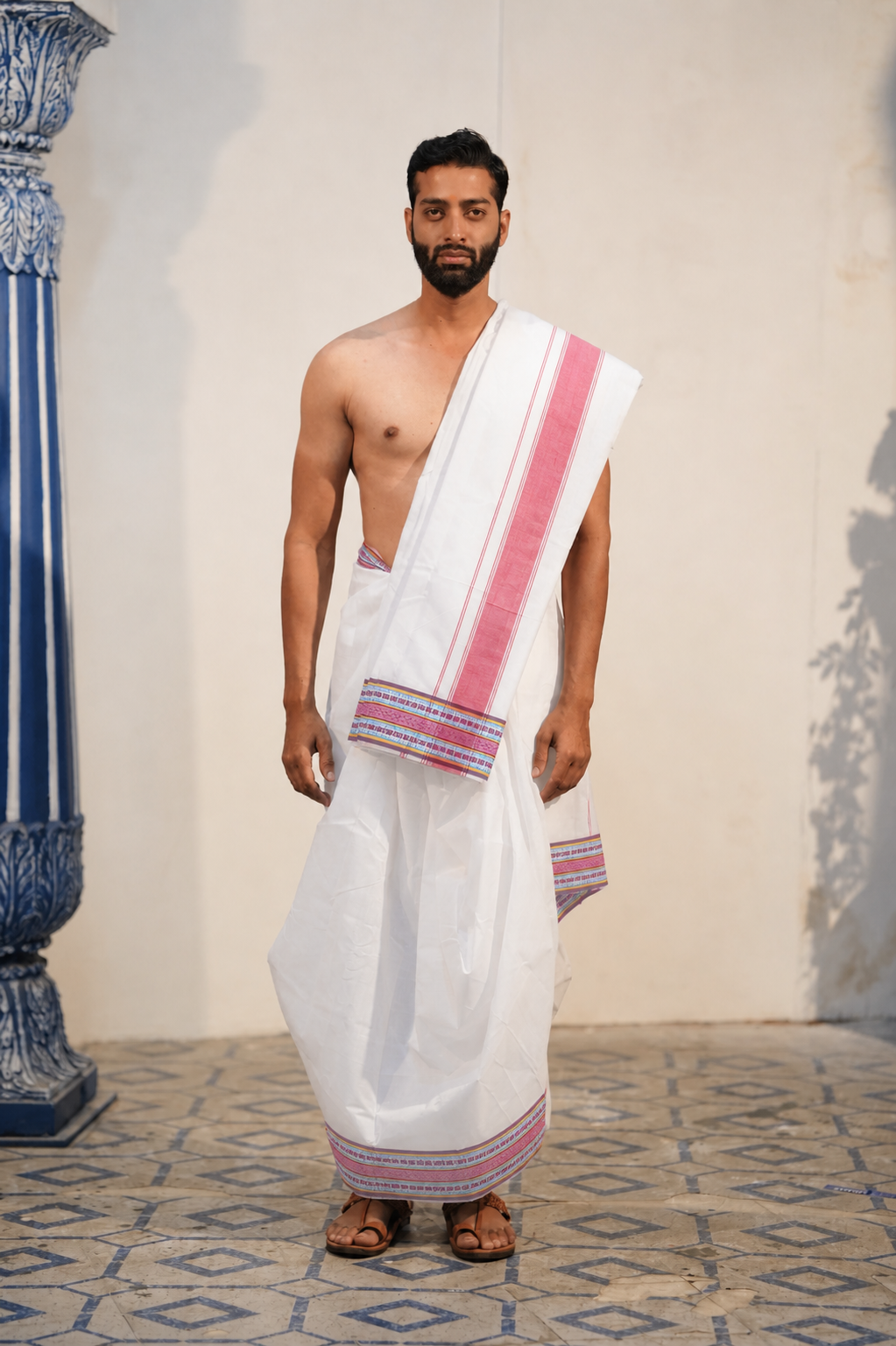 Man wearing a geometric multicolour border white pure cotton dhoti with khes