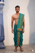Man wearing a gold zari border teal green cotton dhoti with matching uparana