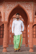 Man wearing a golden border pista green dhoti and shirt combo