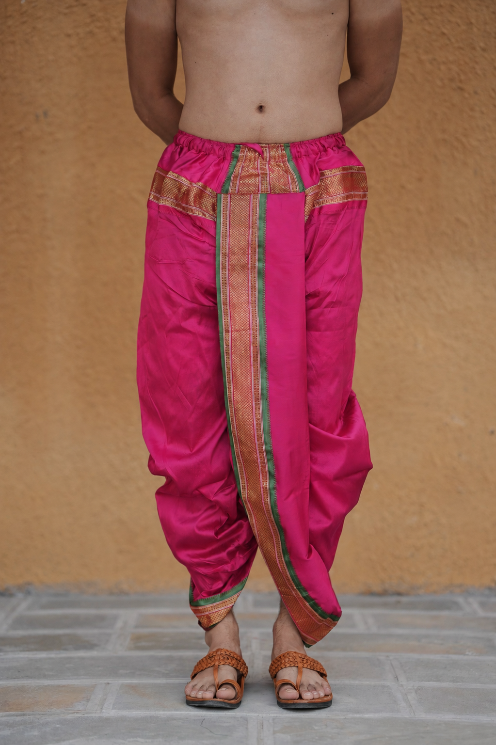 Man wearing a golden border readymade pink dhoti