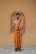 Man wearing a golden elephant design maroon border orange dhoti with uparana