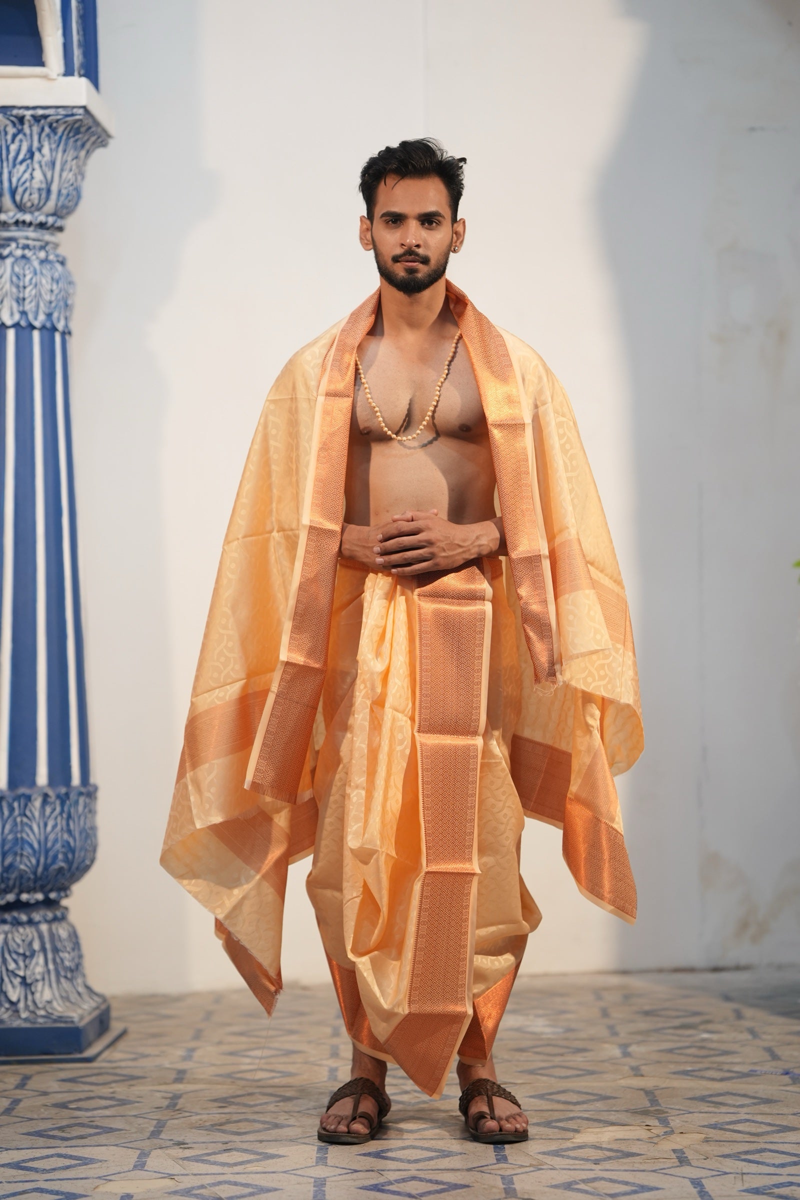 Man wearing golden emboss silk dhoti with matching uparana