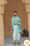 Man wearing a green border abhishek dhoti with matching gamcha