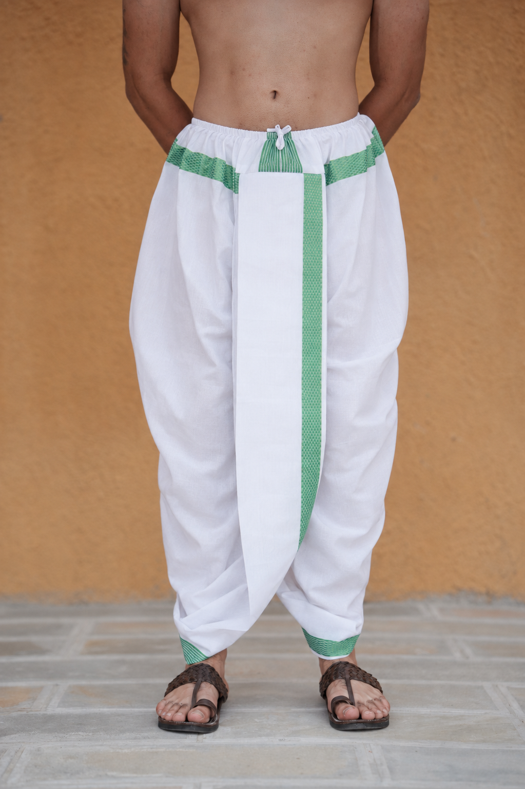 Man wearing a green border readymade white cotton dhoti