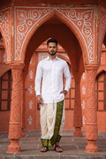 Man wearing a green golden border white dhoti and shirt combo