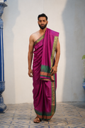 Man wearing a green zari border purple silk dhoti with khes