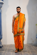 Man wearing a light orange silk dhoti with matching uparana
