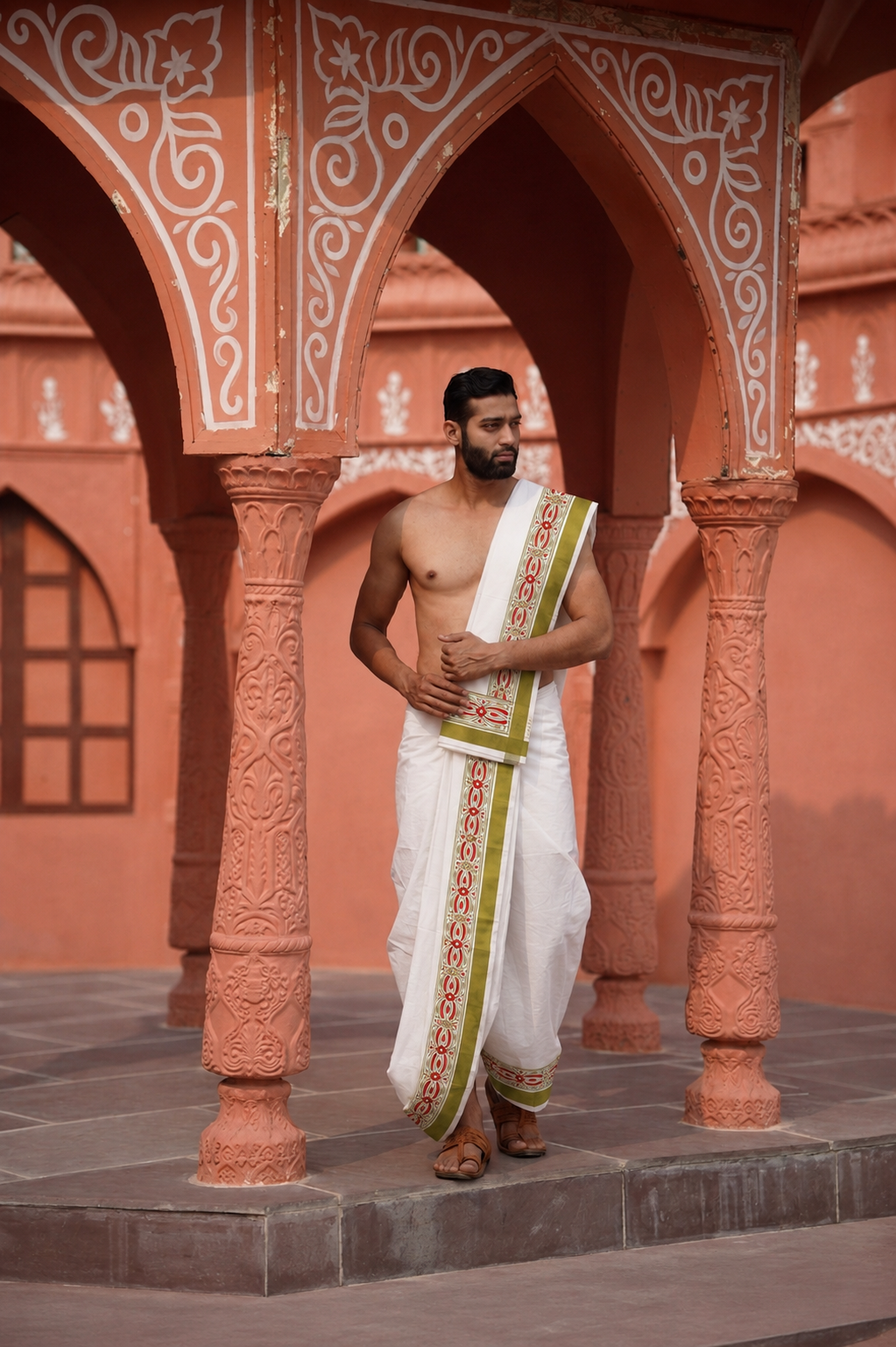 Man wearing a mahendi border thilani motif white cotton dhoti with uparana