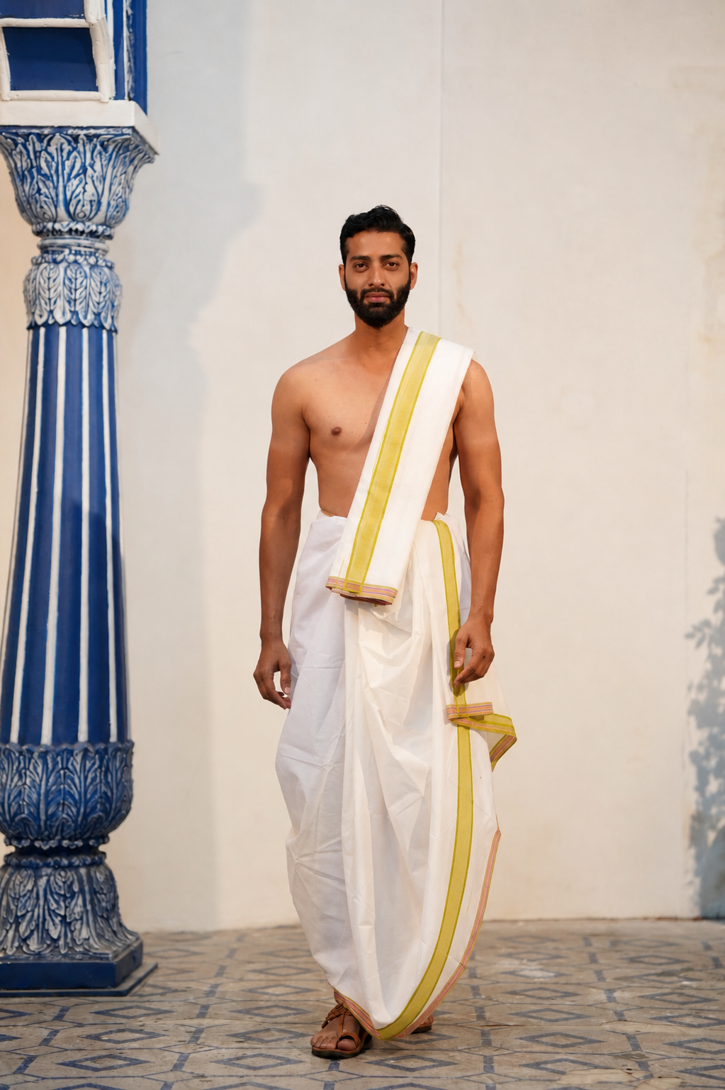 Man wearing a mahendi border white cotton dhoti with matching uparana