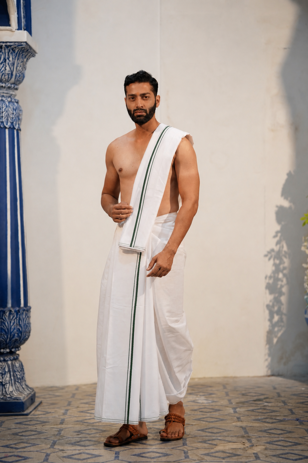 Man wearing a minister style green border white cotton dhoti with matching uparana