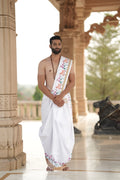 Man wearing a motif handprinted cow border cotton dhoti with khes