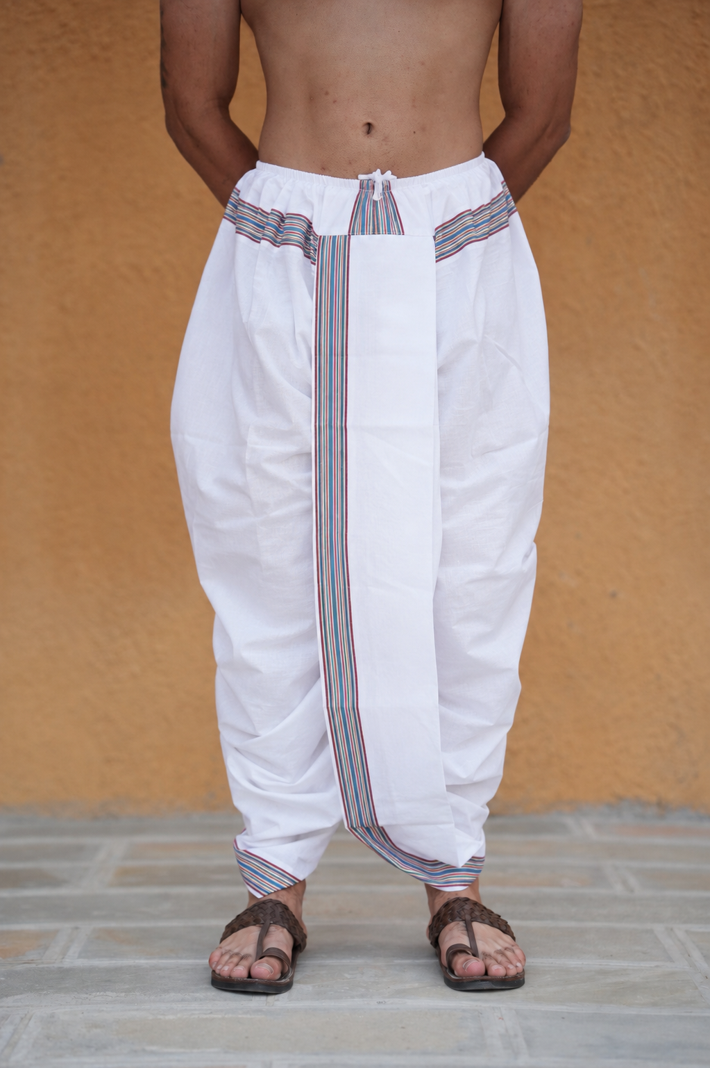 Man wearing a multicolor border white readymade dhoti