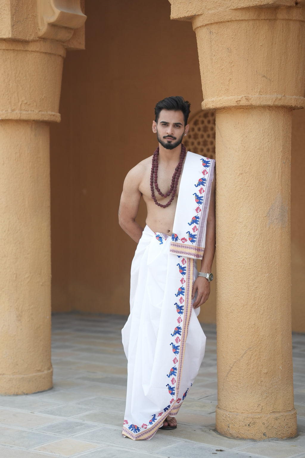 Man wearing a multicolor elephant handprint cotton dhoti with uparana