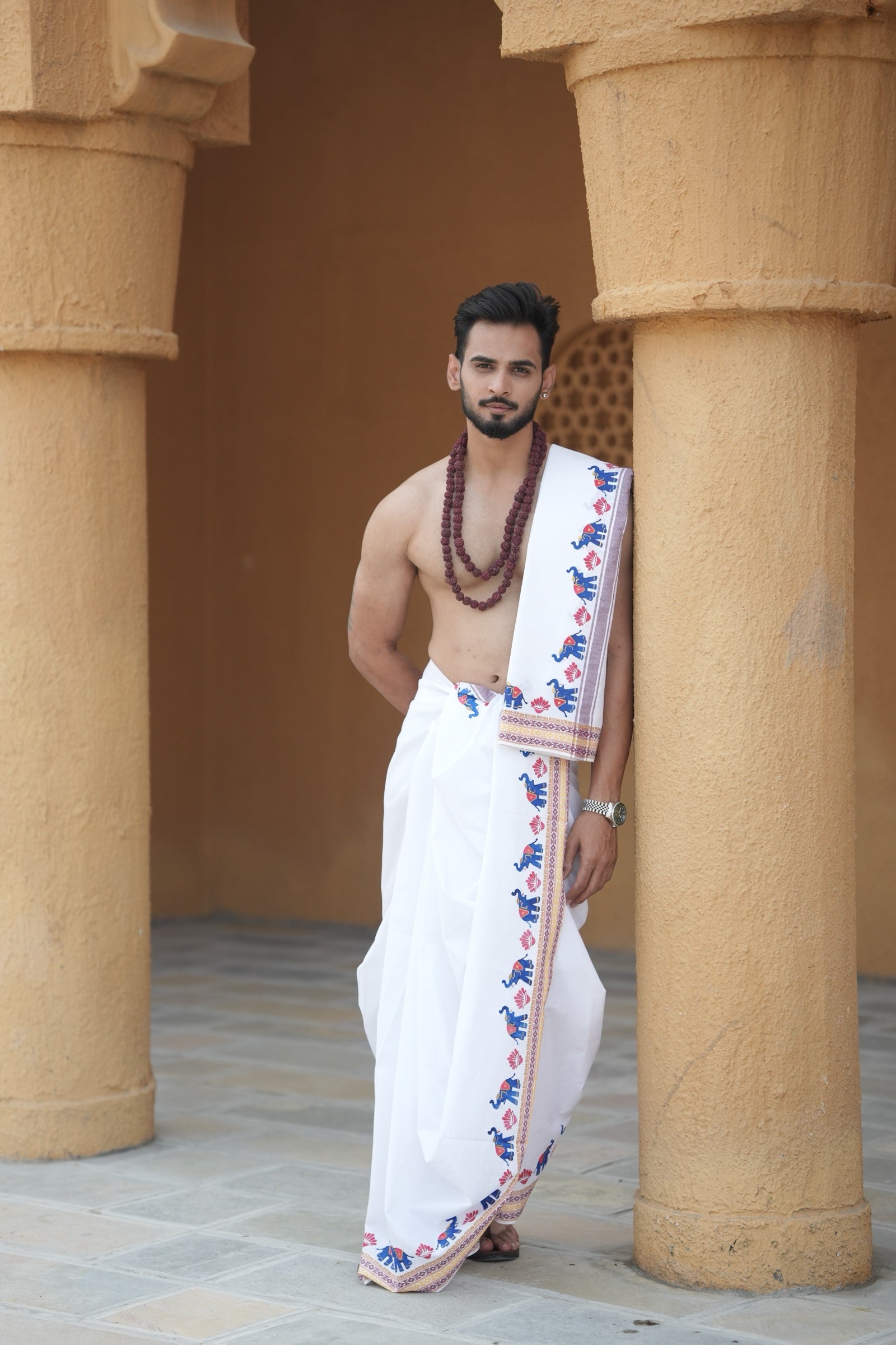 Man wearing a multicolor elephant handprint cotton dhoti with uparana