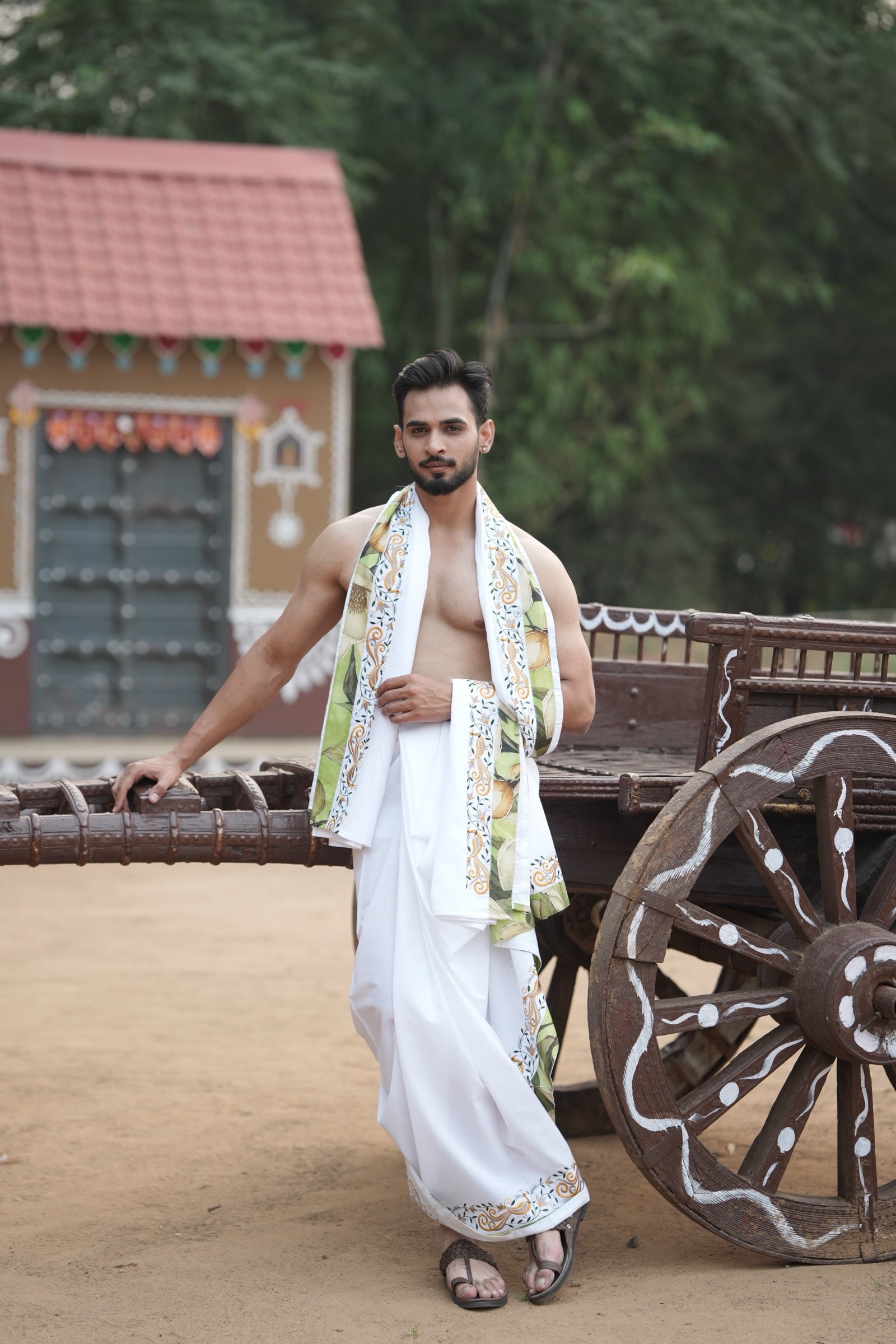 Man wearing a multicolour floral and peacock design border white cotton dhoti with matching uparana