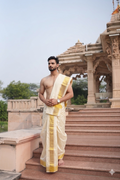 Man wearing a elegent off white pue silk dhoti with angavastram