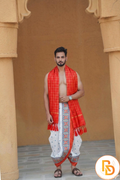 Man wearing a orange border white abhishek dhoti with gamcha