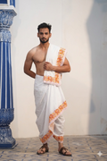 Man wearing a orange & yellow floral embroidery border cotton dhoti with angavastram 