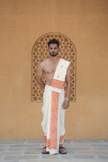 Man wearing a peach floral border white block print cotton dhoti with khes