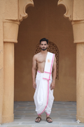 Man wearing a pink bordered white cotton dhoti with matching uparana