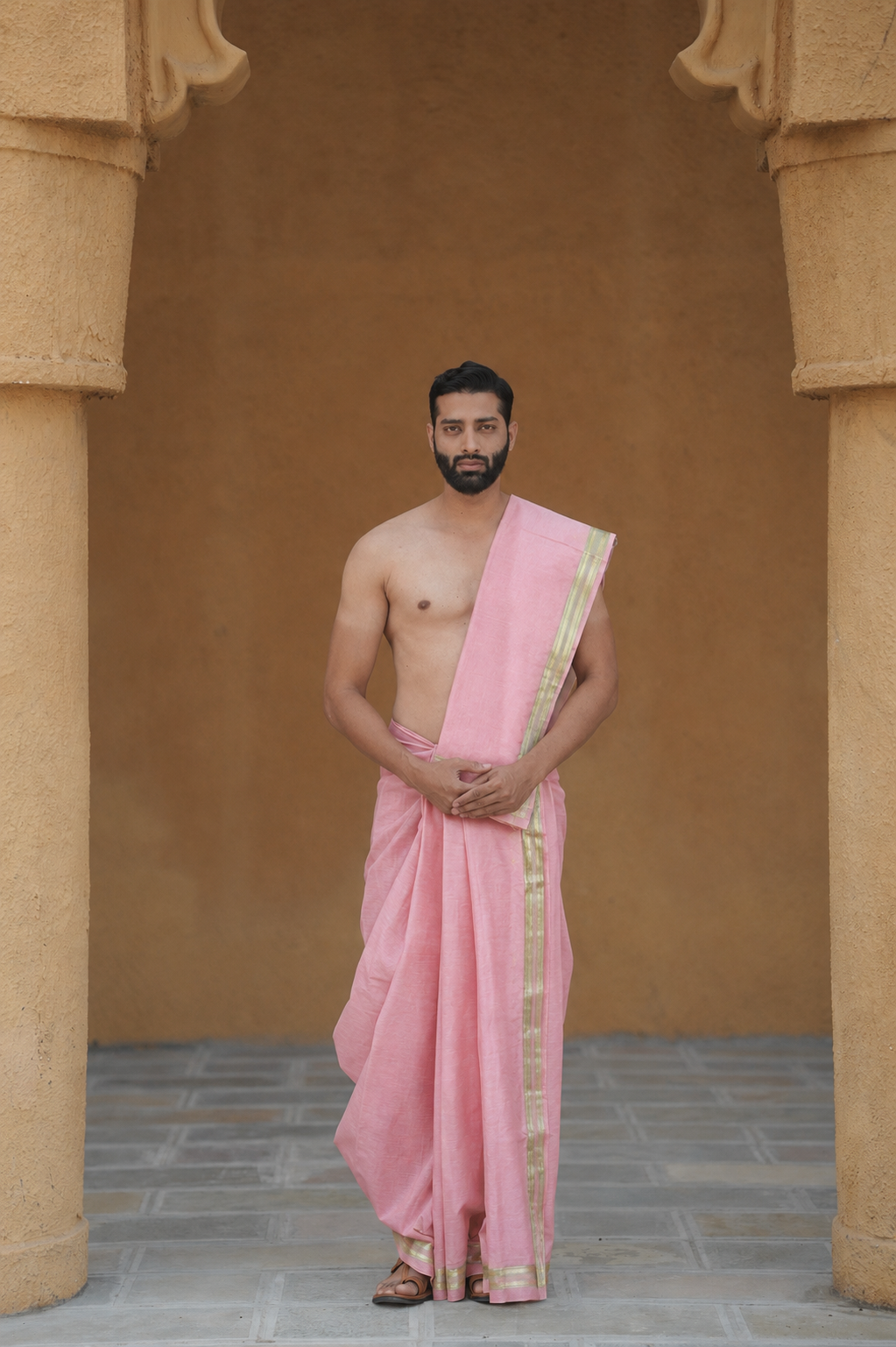 Man wearing a pink golden border semi silk dhoti with uparana
