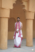 Man wearing a pink zari border & multicolor leaf weave white cotton dhoti with uparana