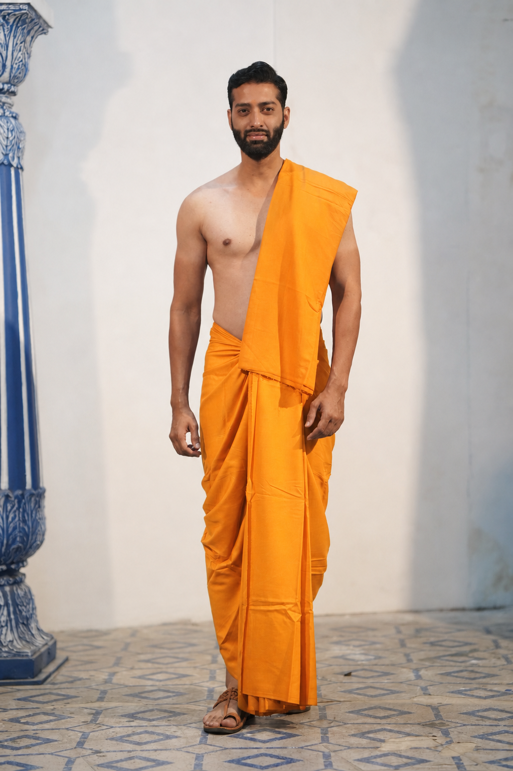 Man wearing a plain light orange cotton dhoti with khes