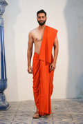Man wearing a plain orange cotton dhoti with matching khes